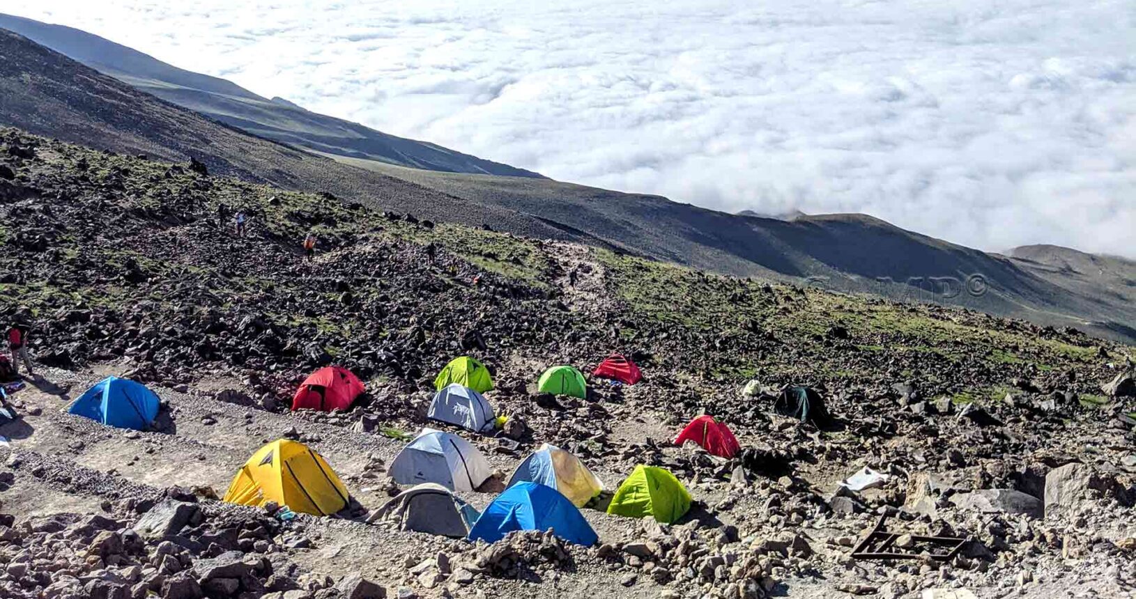 A few steps higher: Overlooking the designated area for tents at Camp 3 of Mount Damavand.