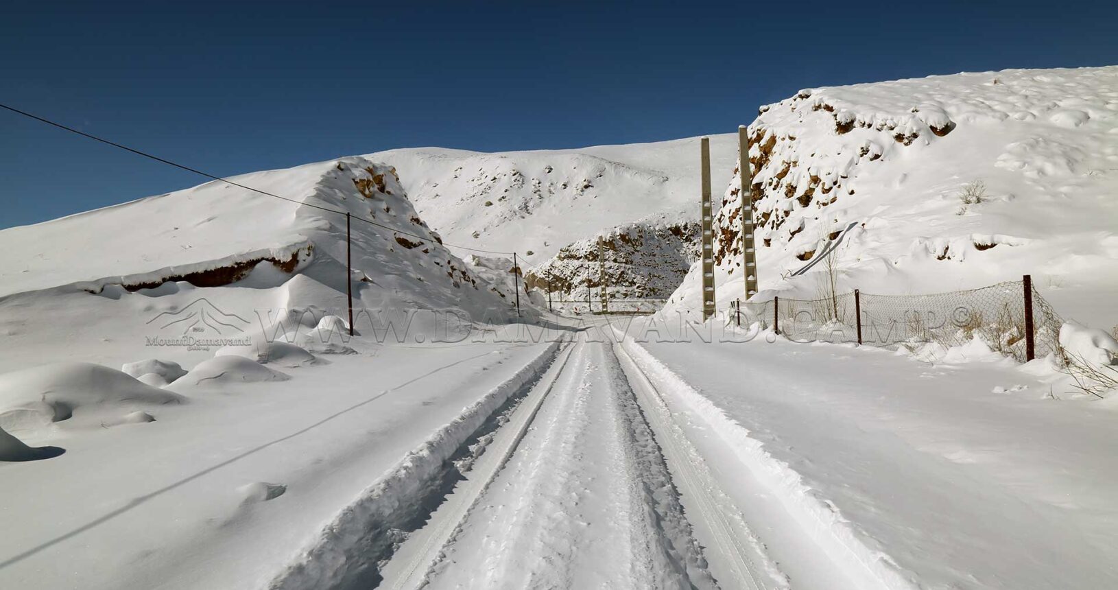 The road near Camp 1 of Mount Damavand is blanketed in a thick layer of snow.