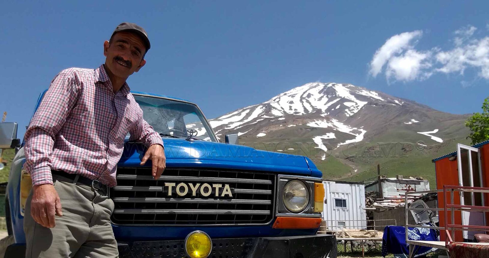 Mr. Faramarzpour is with his car at Camp 2, with Mount Damavand visible in the background.